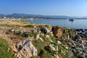 Fototapeta na wymiar Rocky coastline of Antibes, commune is a Mediterranean resort in the Alpes-Maritimes department of southeastern France, on the Côte d'Azur between Cannes and Nice, arrondissement of Grasse