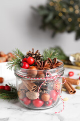 Aromatic potpourri in glass jar on white table