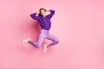 Full size photo of optimistic girl jump wear lilac sweater trousers sneakers isolated on pink color background