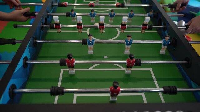 Foosball. Hands of a man playing table football