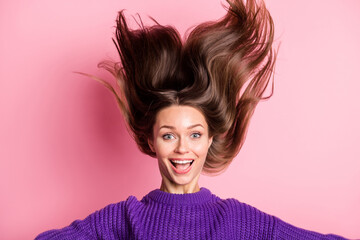 Portrait of astonished pretty lady open mouth hair flying wear purple pullover isolated on pink...