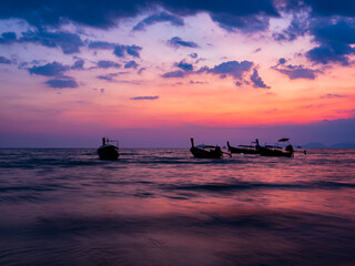Traditional thai boats at sunset beach. Ao Nang Krabi province