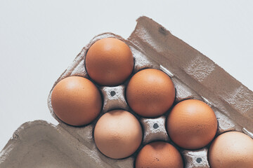 chicken eggs in a cardboard box on white background