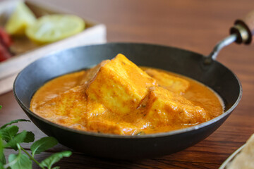 Paneer butter masala , pouring cream on Paneer tikka masala curry Delhi Mumbai North Indian vegetarian side dish Cooking butter paneer made using cottage cheese, Indian spices , footage Kerala, 