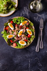 salad Nicoise with tuna, eggs, green beans, tomatoes,  olives, lettuce and anchovies