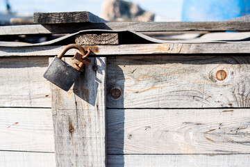 Old padlock on wooden box