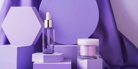 Hyaluronic acid serum bottle and anti aging cream on purple background displayed on geometric shape podiums on silk background