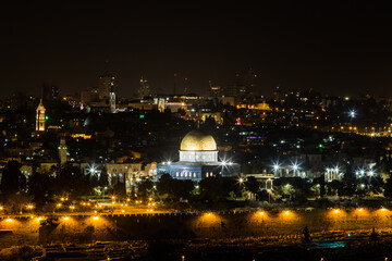 Fototapeta na wymiar Dome of the Rock Mosque in Jerusalem at night. Night view from the Olive Mountain. Cityscape of the Old City of Jerusalem at the evening.