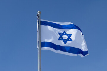 National flag, symbol of Israel in blue and white color blowing in the wind. Israel flag flapping in the wind.