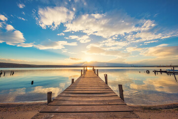 Fototapeta na wymiar Old wooden dock at the lake, sunset shot