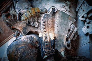 Military armor and weapon of grim old  guardian soldier. Fragment of an ancient statue.