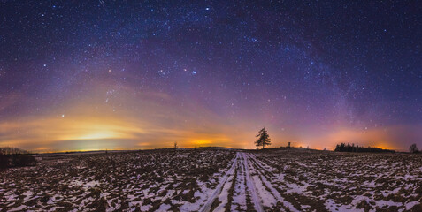 Milky way galaxy, night sky panorama with stars and snow on foreground