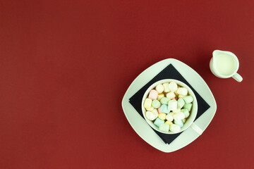 Marshmallow with coffee in a white cup and saucer