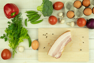 Raw chicken eggs and fresh, healthy vegetables