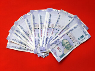 New Indian currency bank notes of RS 100 in Red background, Business and finance 