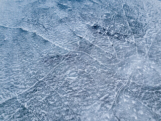 Frosty pattern on the river. Aerial drone view. Sunny winter day, thin ice on the river.