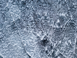 Frosty pattern on the river. Aerial drone view. Sunny winter day, thin ice on the river.