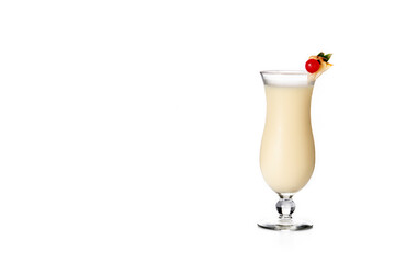 Pina colada cocktail decorated with a piece of pineapple and cherry isolated on white background. Copy space
