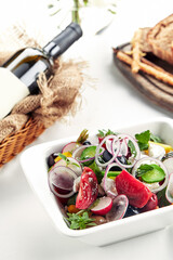 Classic Greek salad. Banquet festive dishes. Gourmet restaurant menu. White background.