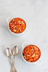 Indian Gajar Ka Halwa, Sweet Indian Dessert Pudding, Garnished with Almonds and Cashew, Top Down Photo