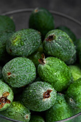 Feijoa whole on black background. Exotic fruit. Selective focus. Closeup.