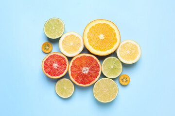 Fresh juicy citrus fruits on light blue background, flat lay