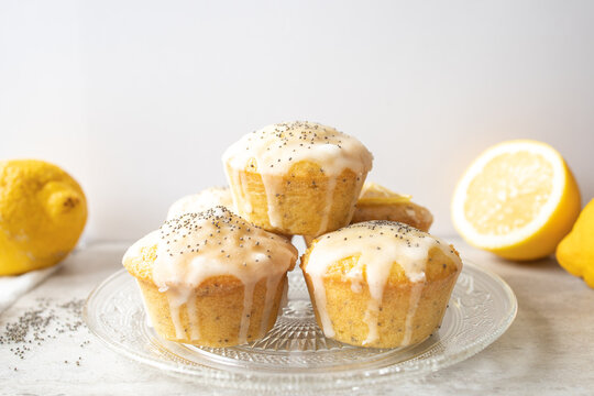 A stack of delicious homemade lemon poppy seed muffins on bright background.