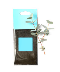 Scented sachet and eucalyptus branches on white background, top view