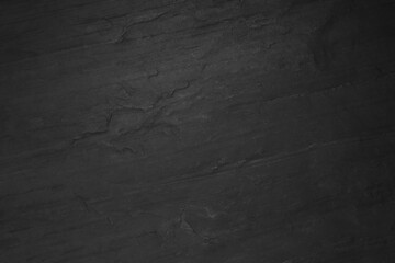 Black slate surface as background, top view