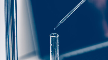 close up. scientist in a glove fills test tubes with a pipette .
