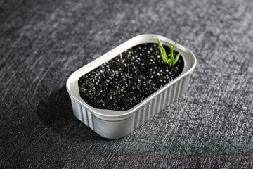 Fish black caviar on a dark stone