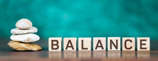Balance stones on blue background. Web banner with text and cubes.