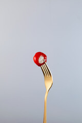 Small peppers stuffed soft cream cheese on golden fork. Delicious appetizer