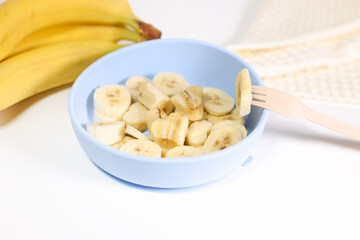 banana cut into slices in a roll, baby food, horizontal image