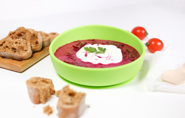 beetroot soup. children food. soup in a plate. on white background. side view