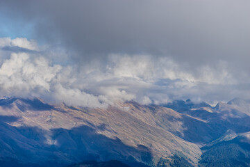 Fototapeta premium the top of the mountain on the background of the autumn sky