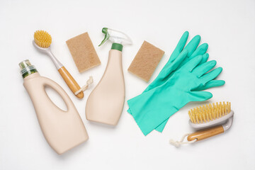 Brushes, sponges, rubber gloves and natural cleaning products on white background.  Eco-friendly...