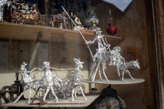 Handmade aluminum foil figures displayed on a window shelf