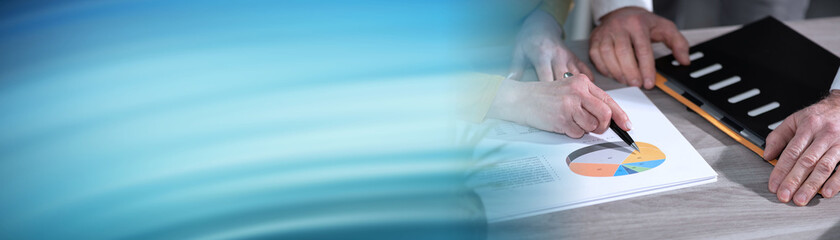 Coworkers analysing financial data; panoramic banner