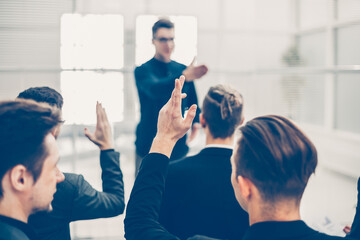 rear view. employees ask questions at a business briefing