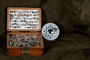 Wooden Fly Box and Fly Reel on an Outdoor Coat