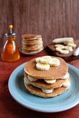 A stack of banana pancakes on a blue plate. Traditional American Breakfast. The concept of home made healthy food. Copy space.