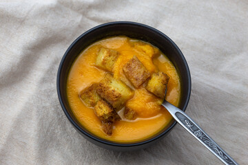 Pumpkin soup served with croutons