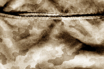 Old camouflage cloth with blur effect in brown tone.