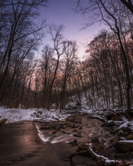 A snowy pre-dawn winter scene along a creek at Scott's Run Nature Preserve