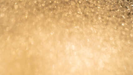Beautiful abstract de-focused glitter vintage golden lights photo background