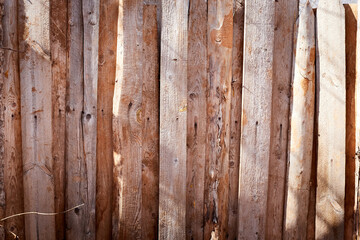 Wooden fence made of wooden narrow boards. Background and texture