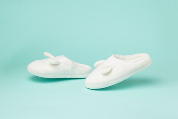 Walking white house slippers on a blue background.