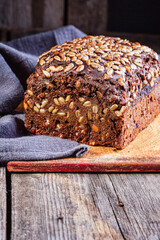 Freshly baked rye bread with seeds is on the kitchen Board. Homemade cake. The fermentation process. Slow baking