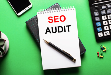 On a green background - a telephone, a calculator and a diary with the inscription SEO AUDIT